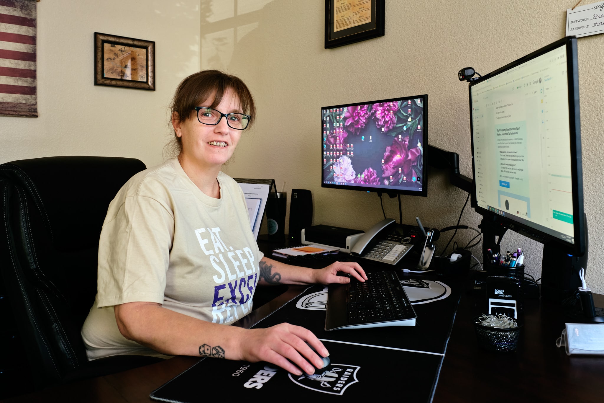 heather smiling at the camera while working on her computer